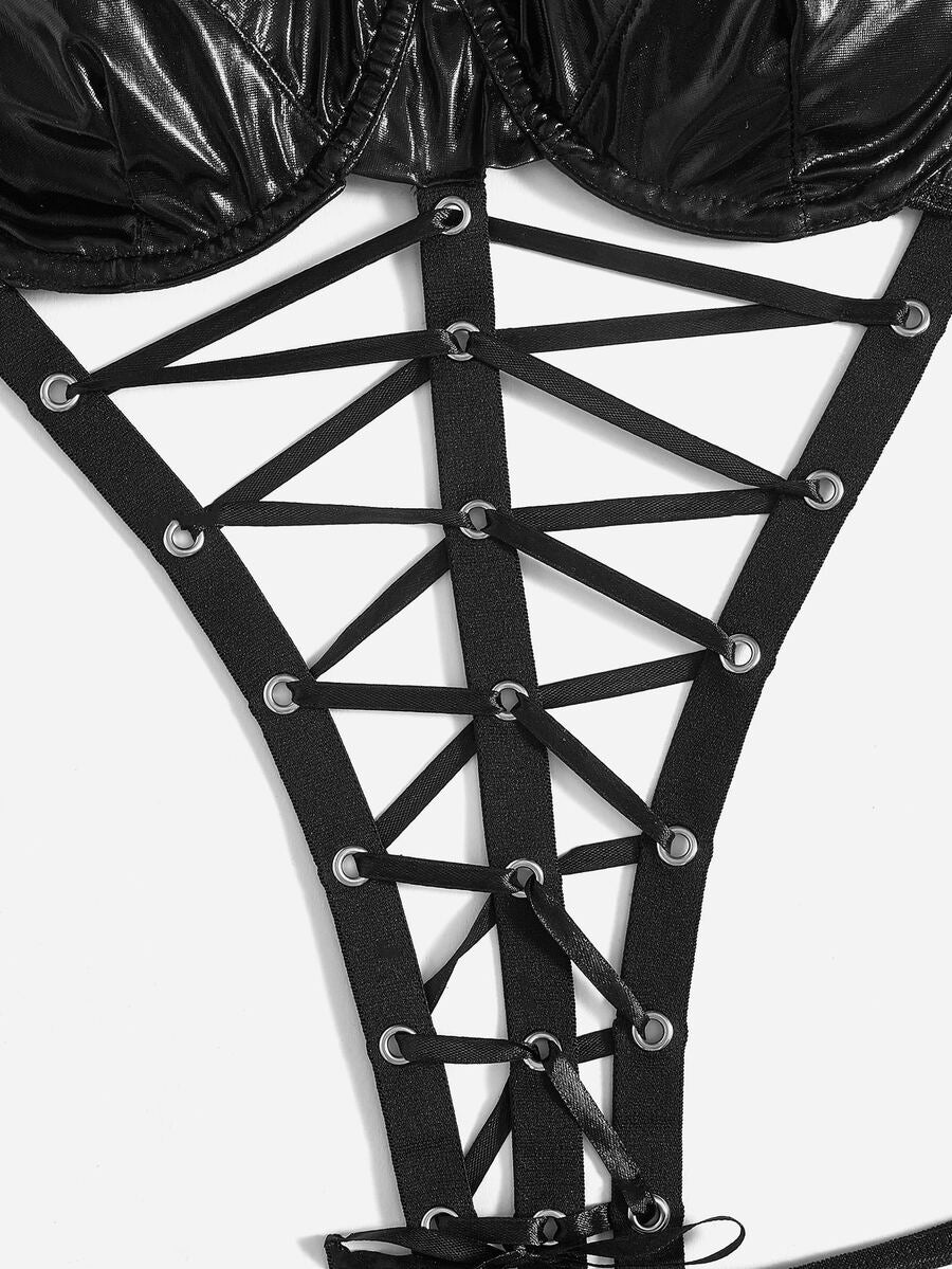 Women's black goth teddy bodysuit featuring front lace-up details, cut-out accent, adjustable spaghetti straps, paired with matching oversleeves.