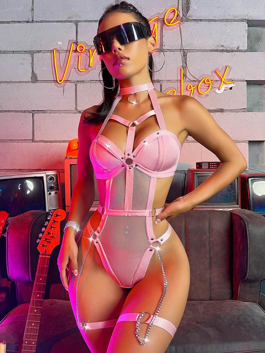 Women's black ring linked harness teddy bodysuit featuring cutout chain details, high rise thong bottom, removable padding, and matching leg rings.