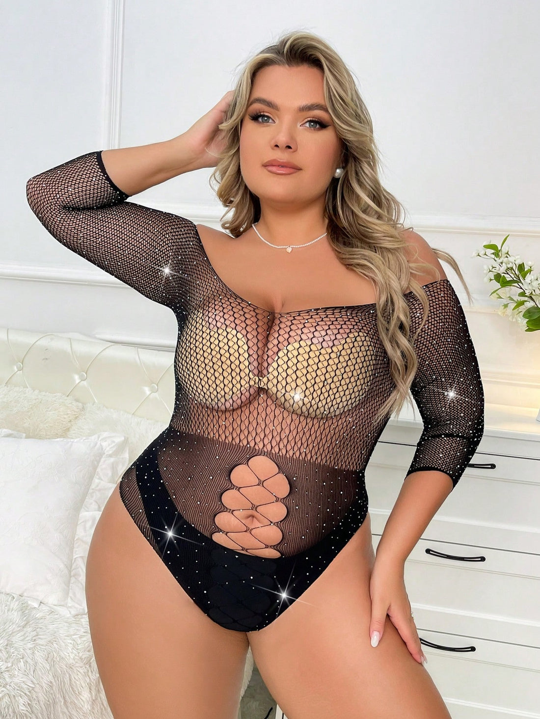 Black plus size rhinestone studded fishnet teddy bodysuit featuring sheer fabric, cut-out details, scoop neckline, and crossback straps.