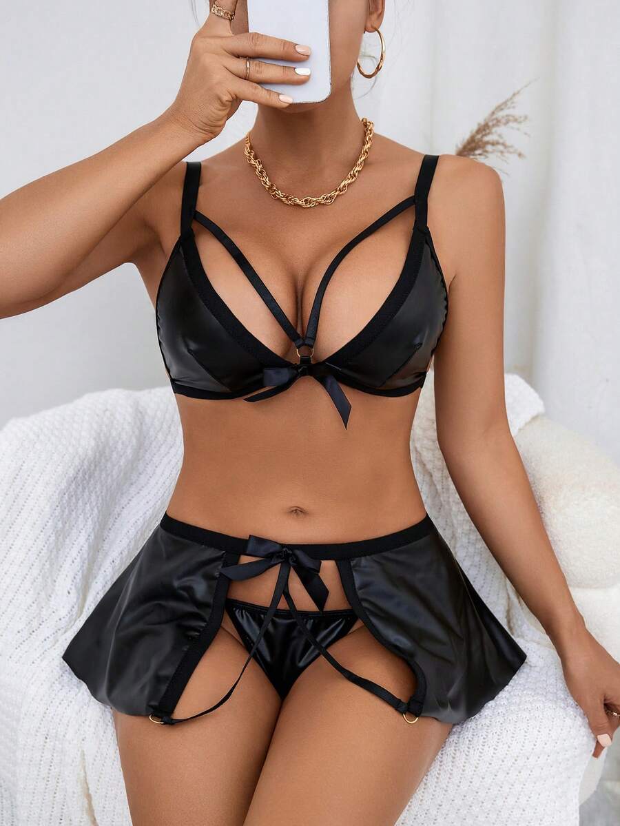 Black 3-piece goth lingerie set featuring a cutout wireless bralette with adjustable spaghetti straps, bow and knot details, paired with a matching low-rise V-string panty and short skirt.