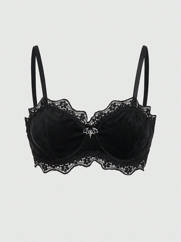 Black velvet and contrast lace underwire bralette featuring a bat shaped pendant, bow detail, adjustable spaghetti straps, and floral pattern.