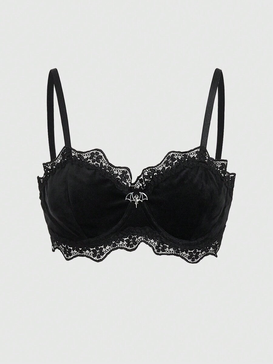 Black velvet and contrast lace underwire bralette featuring a bat shaped pendant, bow detail, adjustable spaghetti straps, and floral pattern.