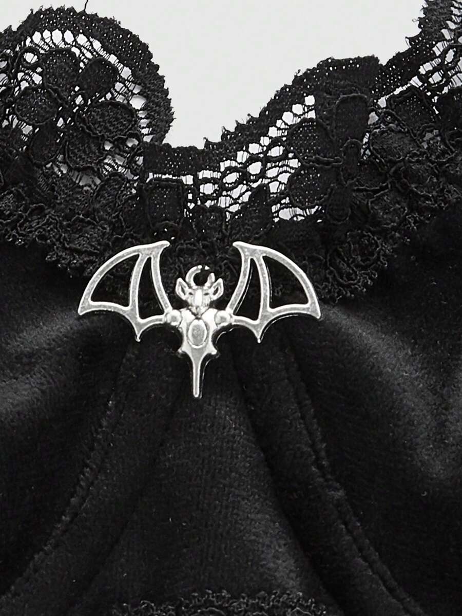 Black velvet and contrast lace underwire bralette featuring a bat shaped pendant, bow detail, adjustable spaghetti straps, and floral pattern.