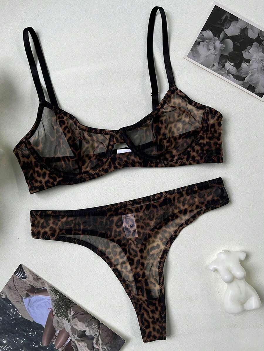 Women's black 2-piece sheer mesh lingerie set featuring an underwire bralette top with cut-out bow details and a matching thong.