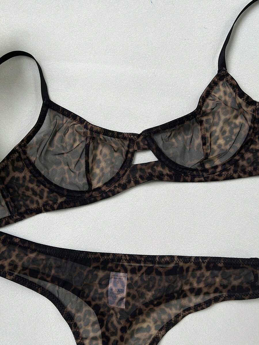 Women's black 2-piece sheer mesh lingerie set featuring an underwire bralette top with cut-out bow details and a matching thong.
