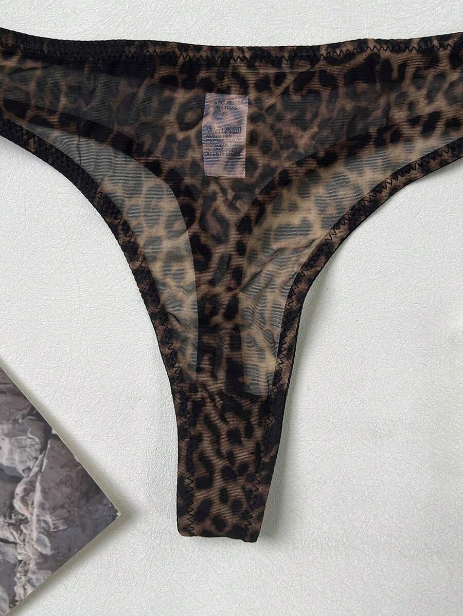 Women's black 2-piece sheer mesh lingerie set featuring an underwire bralette top with cut-out bow details and a matching thong.