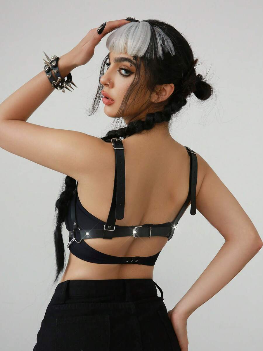 Women's black goth PVC leather strappy harness bra top featuring chain accents and lace-up details.