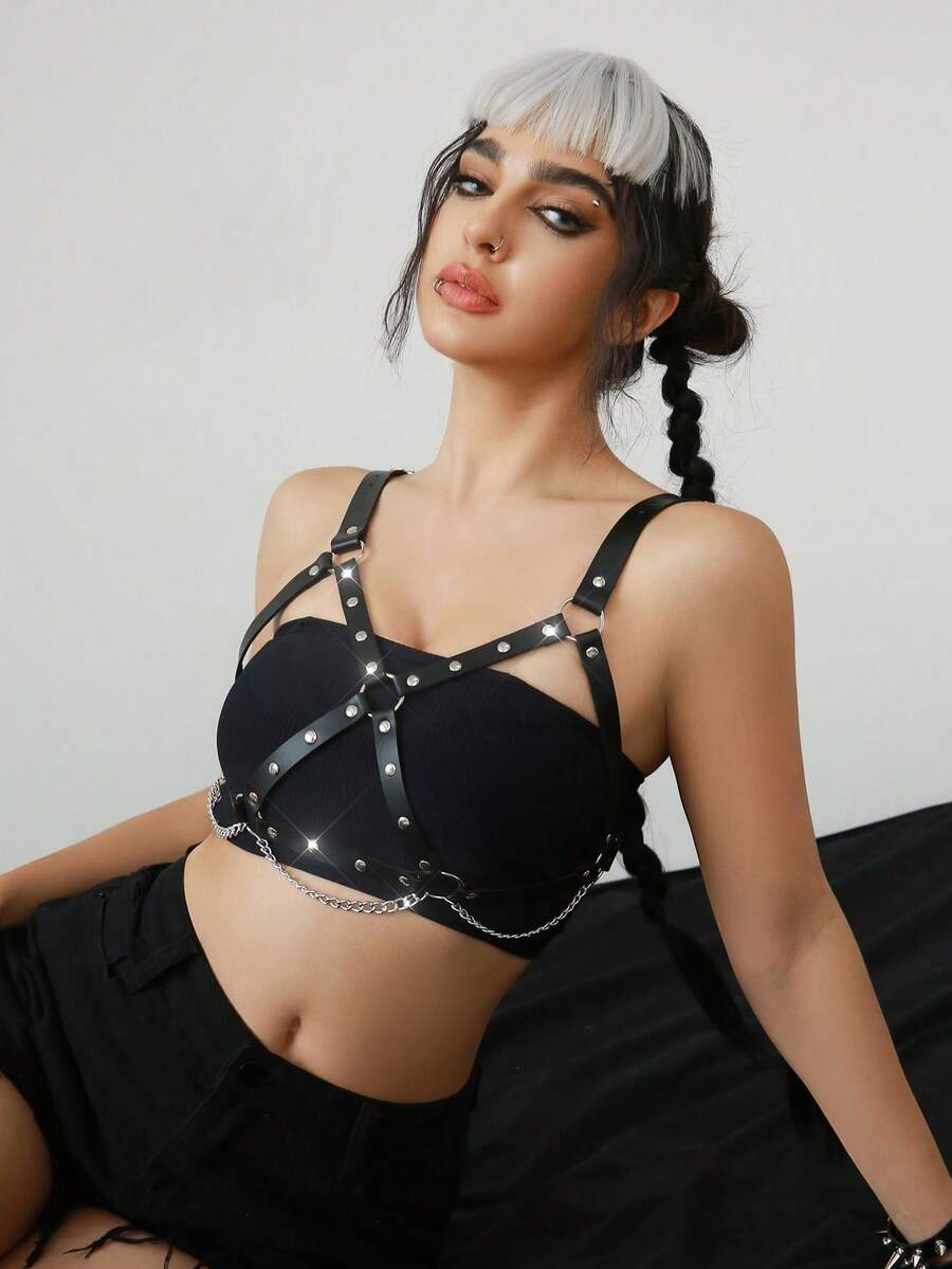 Women's black goth PVC leather strappy harness bra top featuring chain accents and lace-up details.