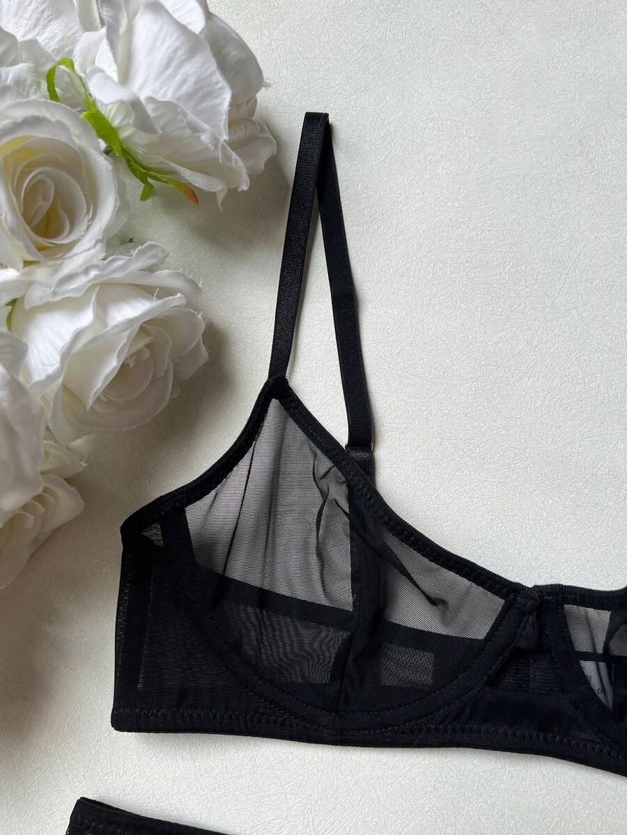 Women's black 2-piece sheer mesh lingerie set featuring an underwire bralette top with cut-out bow details and a matching thong.