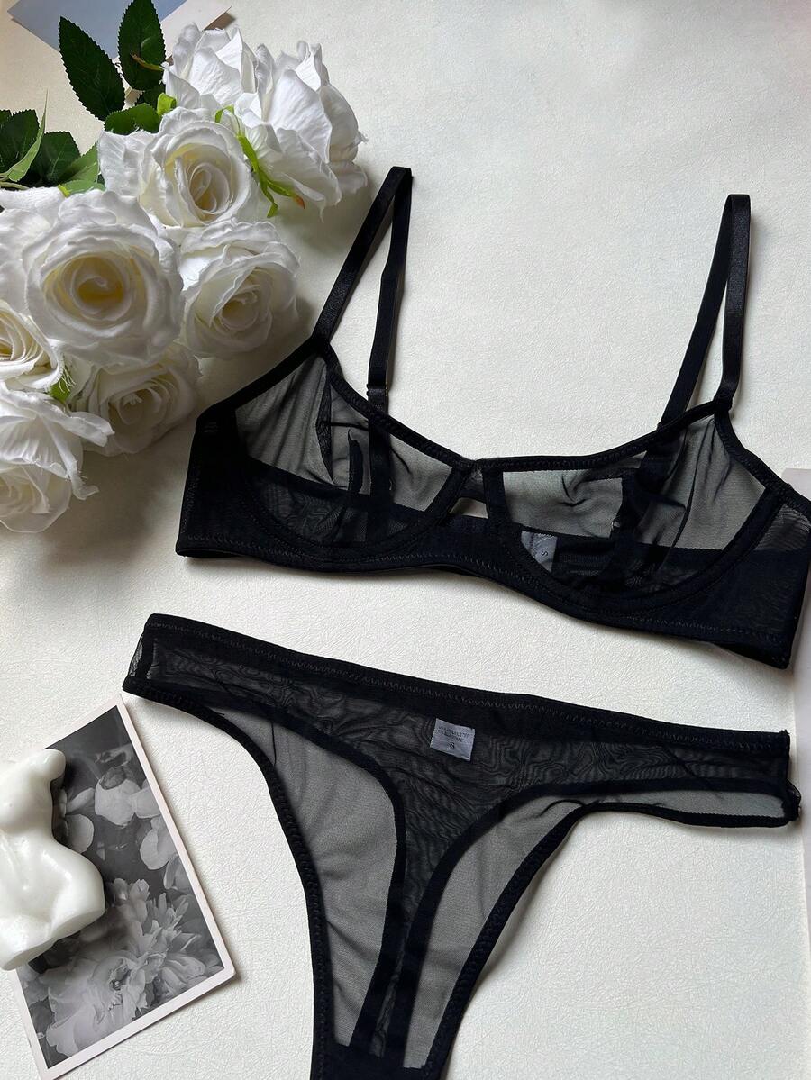 Women's black 2-piece sheer mesh lingerie set featuring an underwire bralette top with cut-out bow details and a matching thong.