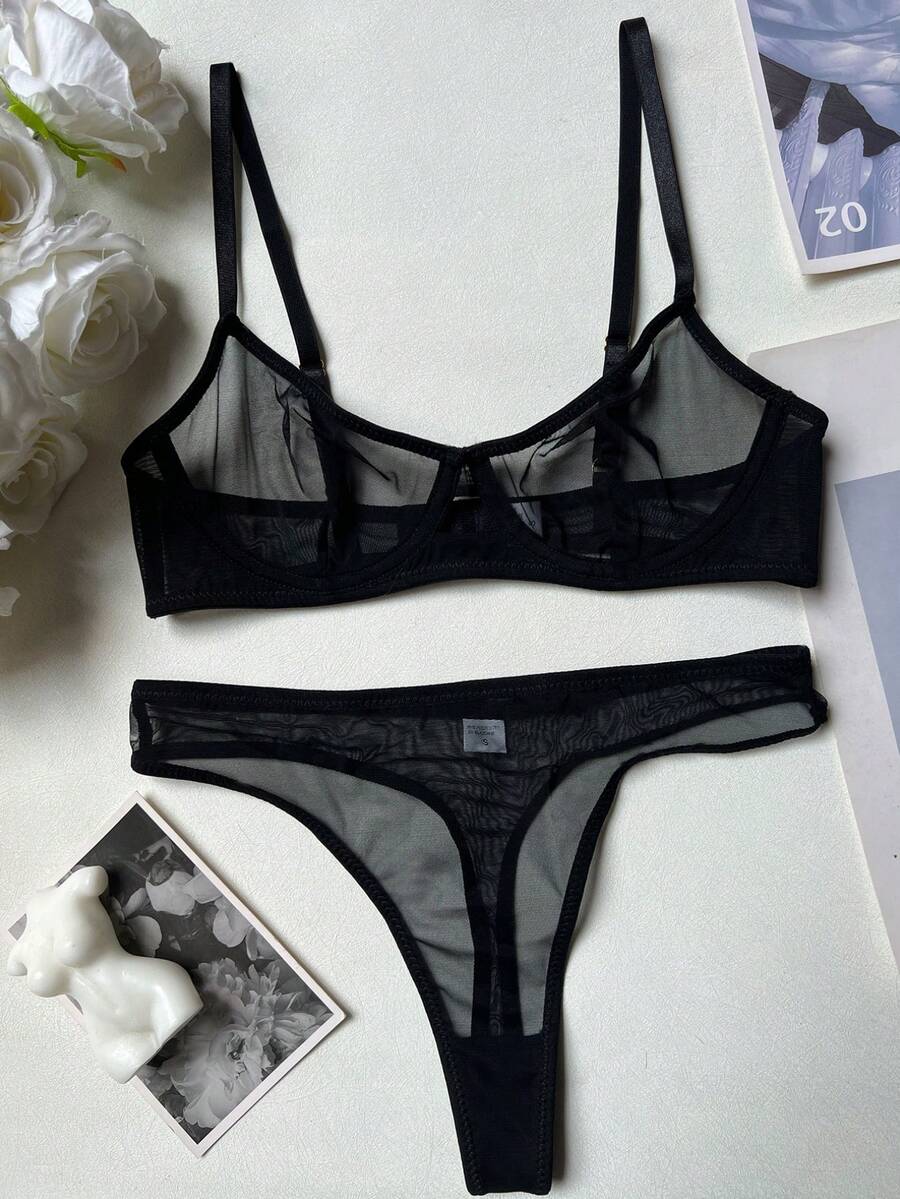 Women's black 2-piece sheer mesh lingerie set featuring an underwire bralette top with cut-out bow details and a matching thong.