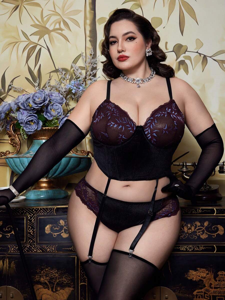 A 2-piece purple plus size velvet lingerie set featuring a contrast lace cut-out babydoll top with adjustable spaghetti straps and matching high rise briefs.
