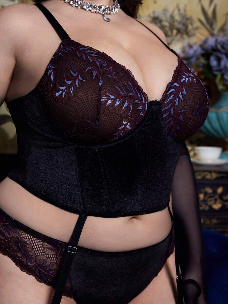 A 2-piece purple plus size velvet lingerie set featuring a contrast lace cut-out babydoll top with adjustable spaghetti straps and matching high rise briefs.