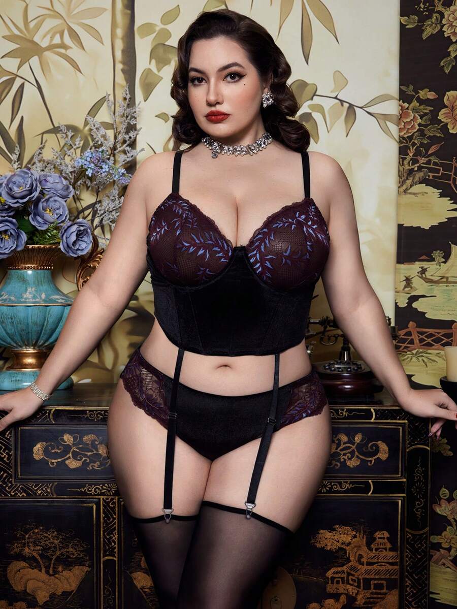 A 2-piece purple plus size velvet lingerie set featuring a contrast lace cut-out babydoll top with adjustable spaghetti straps and matching high rise briefs.