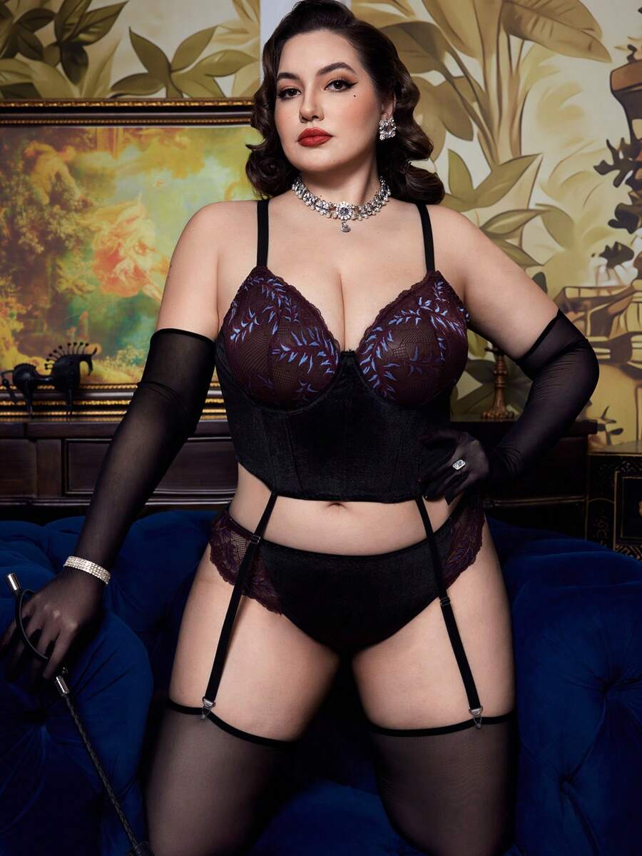 A 2-piece purple plus size velvet lingerie set featuring a contrast lace cut-out babydoll top with adjustable spaghetti straps and matching high rise briefs.