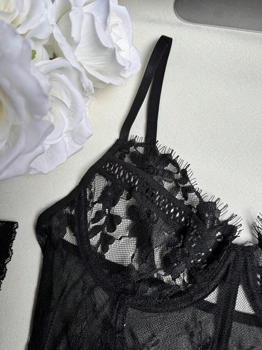 Black 3-piece women's bustier lingerie set featuring an underwire longline top with contrast mesh, matching thong panty, and garter belt.