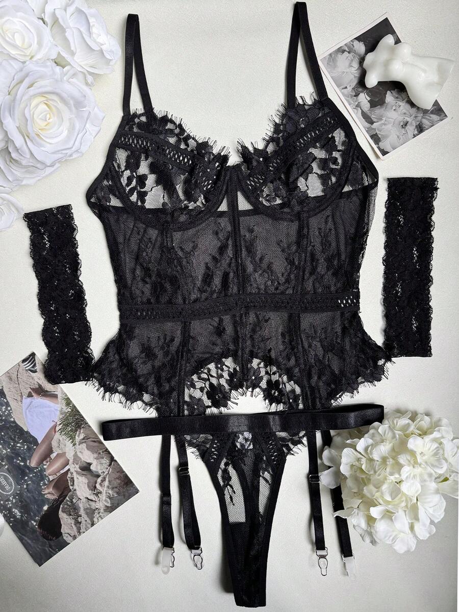 Black 3-piece women's bustier lingerie set featuring an underwire longline top with contrast mesh, matching thong panty, and garter belt.