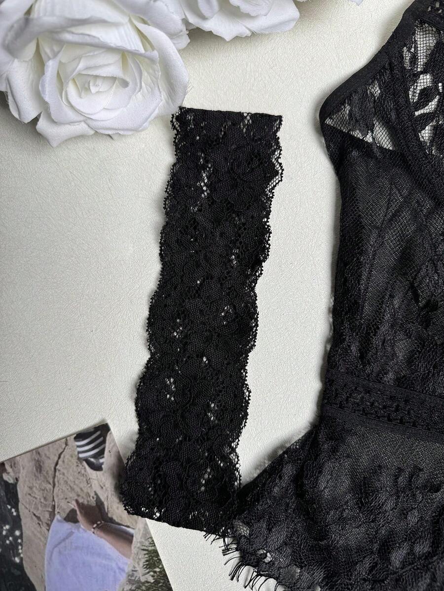 Black 3-piece women's bustier lingerie set featuring an underwire longline top with contrast mesh, matching thong panty, and garter belt.