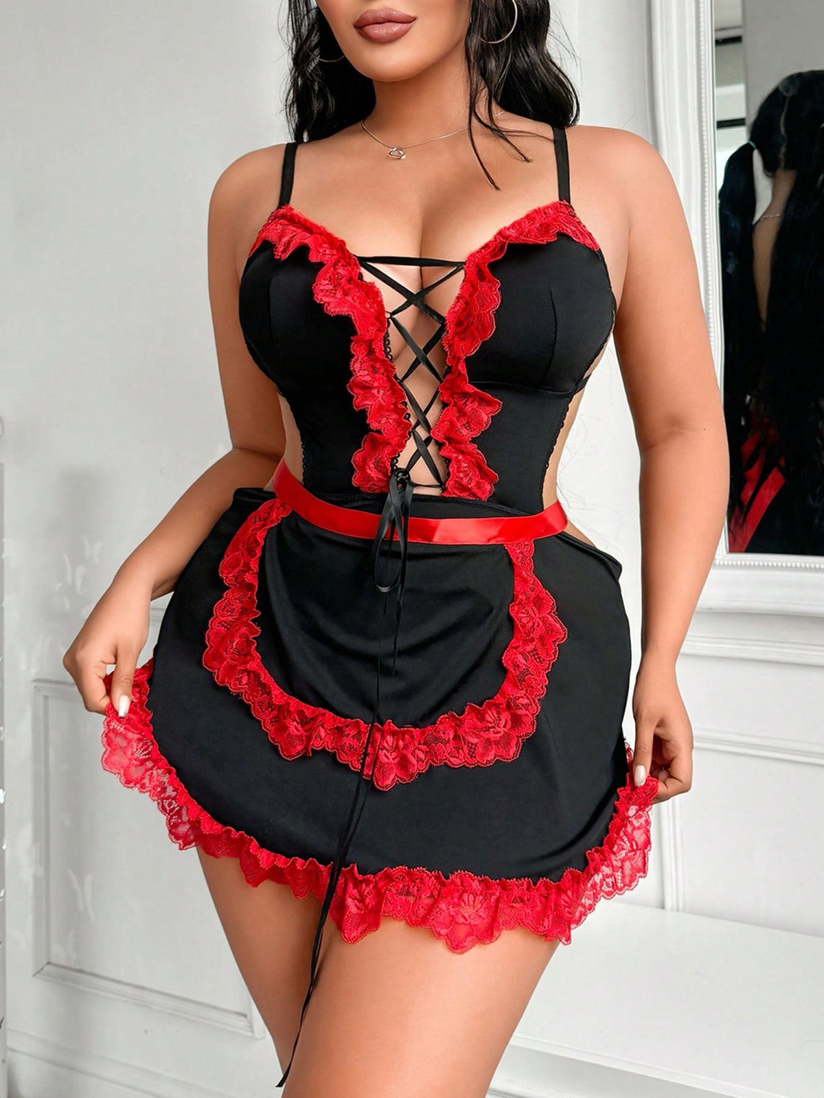 Black 2-piece sexy maid cosplay costume set for women, featuring a spaghetti strap jumpsuit with lace-up criss-cross details and a matching apron.
