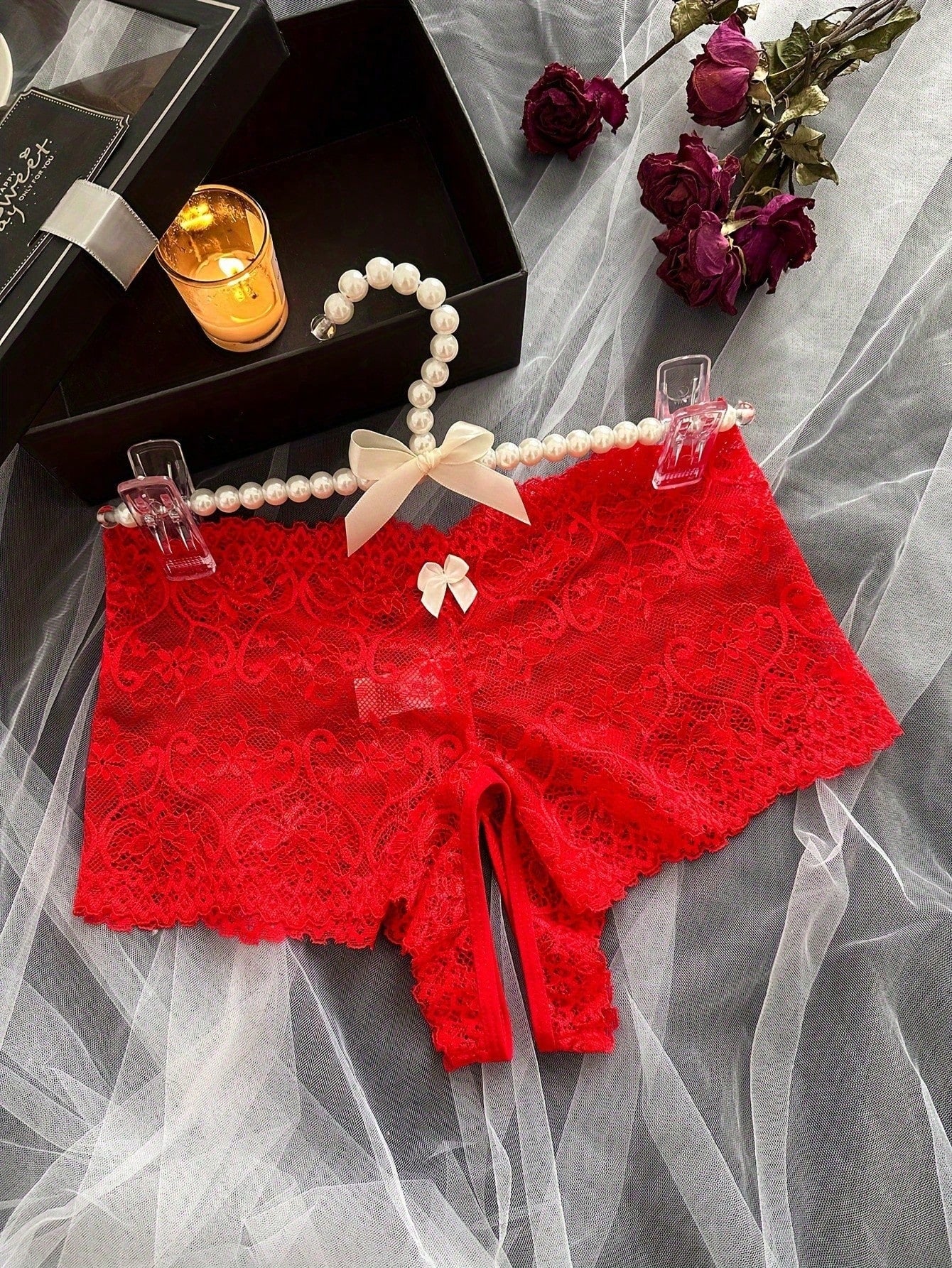 Black women's crotchless lace briefs with a mid-rise fit, textured pattern, cut-out split detail, and slight-stretch romantic styling.
