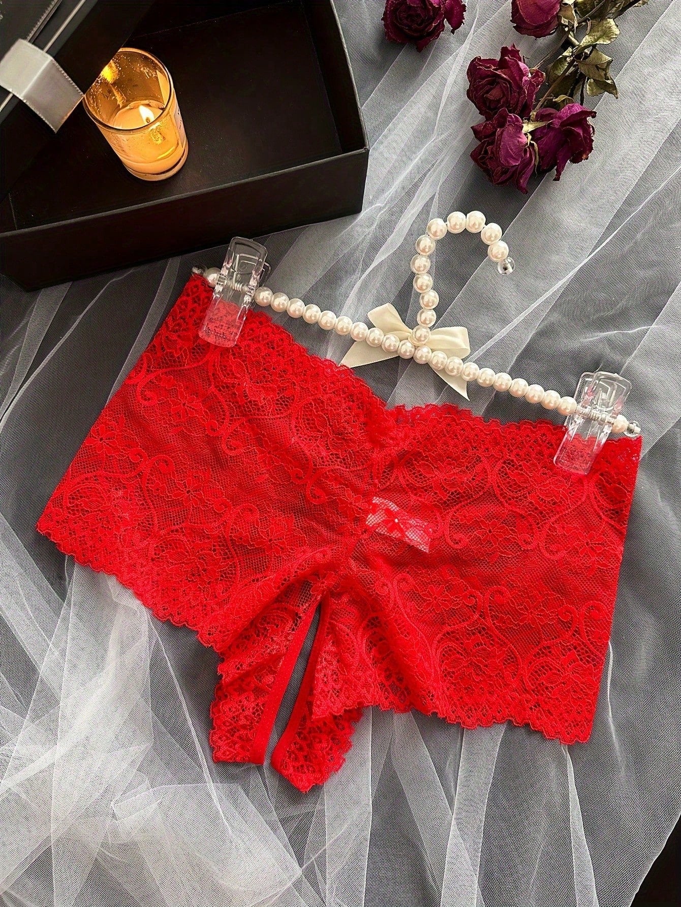 Black women's crotchless lace briefs with a mid-rise fit, textured pattern, cut-out split detail, and slight-stretch romantic styling.