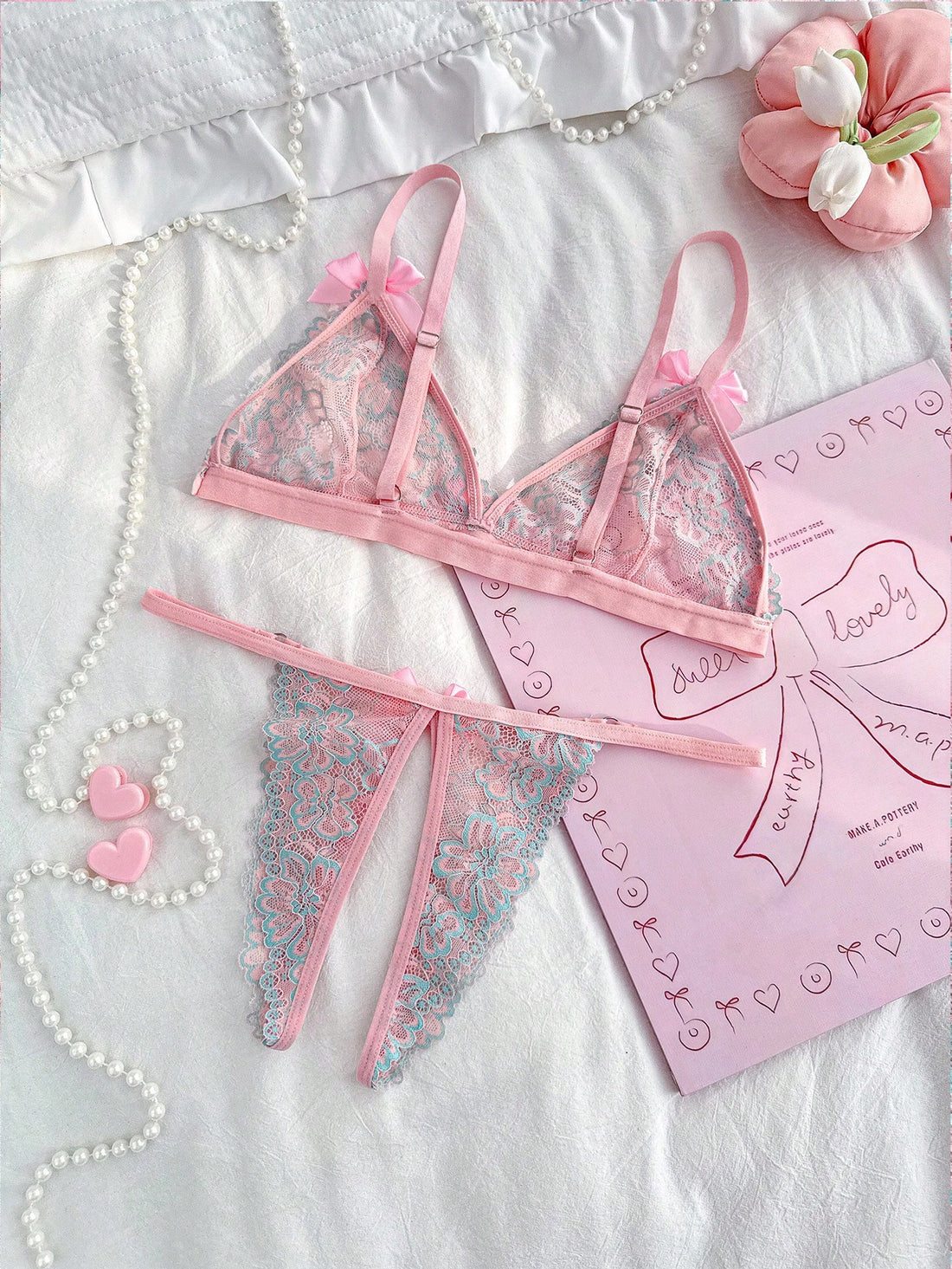 Sheer pink knitted lingerie set for women with a wireless triangle bralette, adjustable spaghetti straps, bow detail, backless design, and matching low-rise briefs.