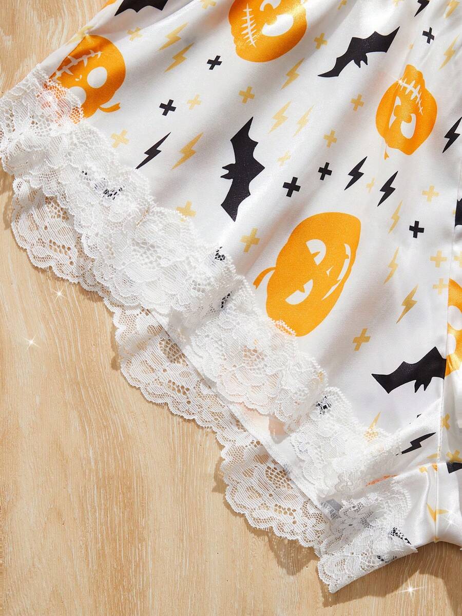 Women's Halloween satin jumpsuit sleepwear with pumpkin lantern and bat print, backless contrast lace design, and adjustable straps.