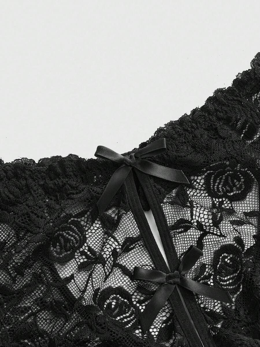 Black lace crotchless panties featuring a gothic hollow heart cutout design in sheer mid-rise fabric for women.