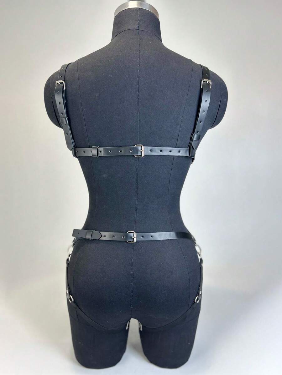 Black PVC leather harness lingerie set for women featuring ring details, restraint straps, thigh garters, and goth Y2K style.