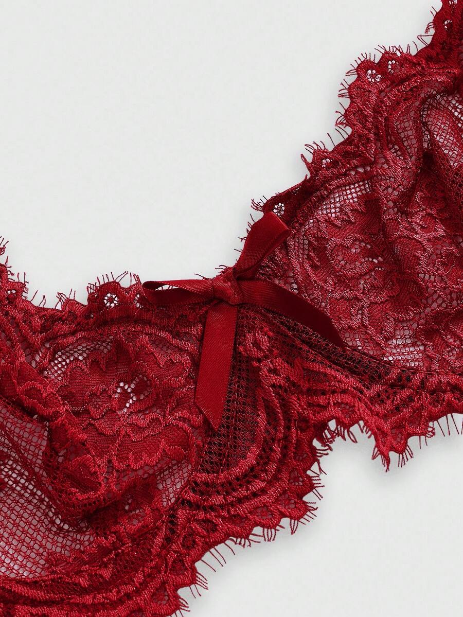Black sheer floral lace plunge bra featuring underwire support, unlined triangle cups, adjustable straps, and a backless design for women.