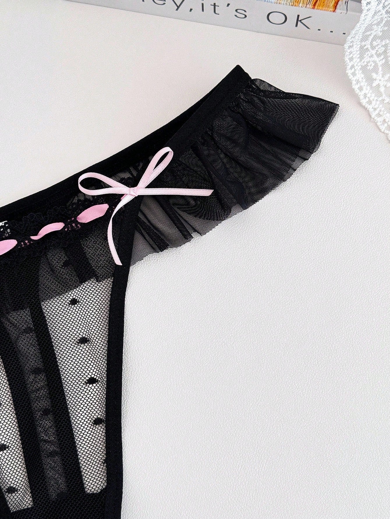 Women's ruffled mesh thong panty with bow detail and mid rise fit, plain design, 1-piece style