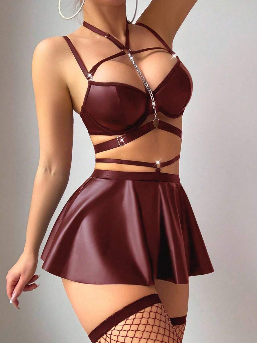 Black 5-piece PU leather lingerie set featuring a chain halter bralette, cut-out mini skirt, and matching thong.