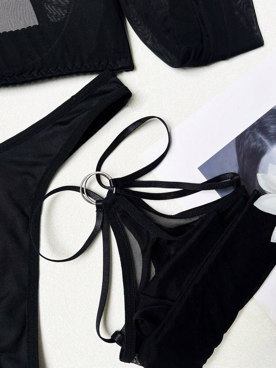 Black sheer cut out lingerie set including triangle cup underwire bralette with adjustable straps and low rise thong panty.