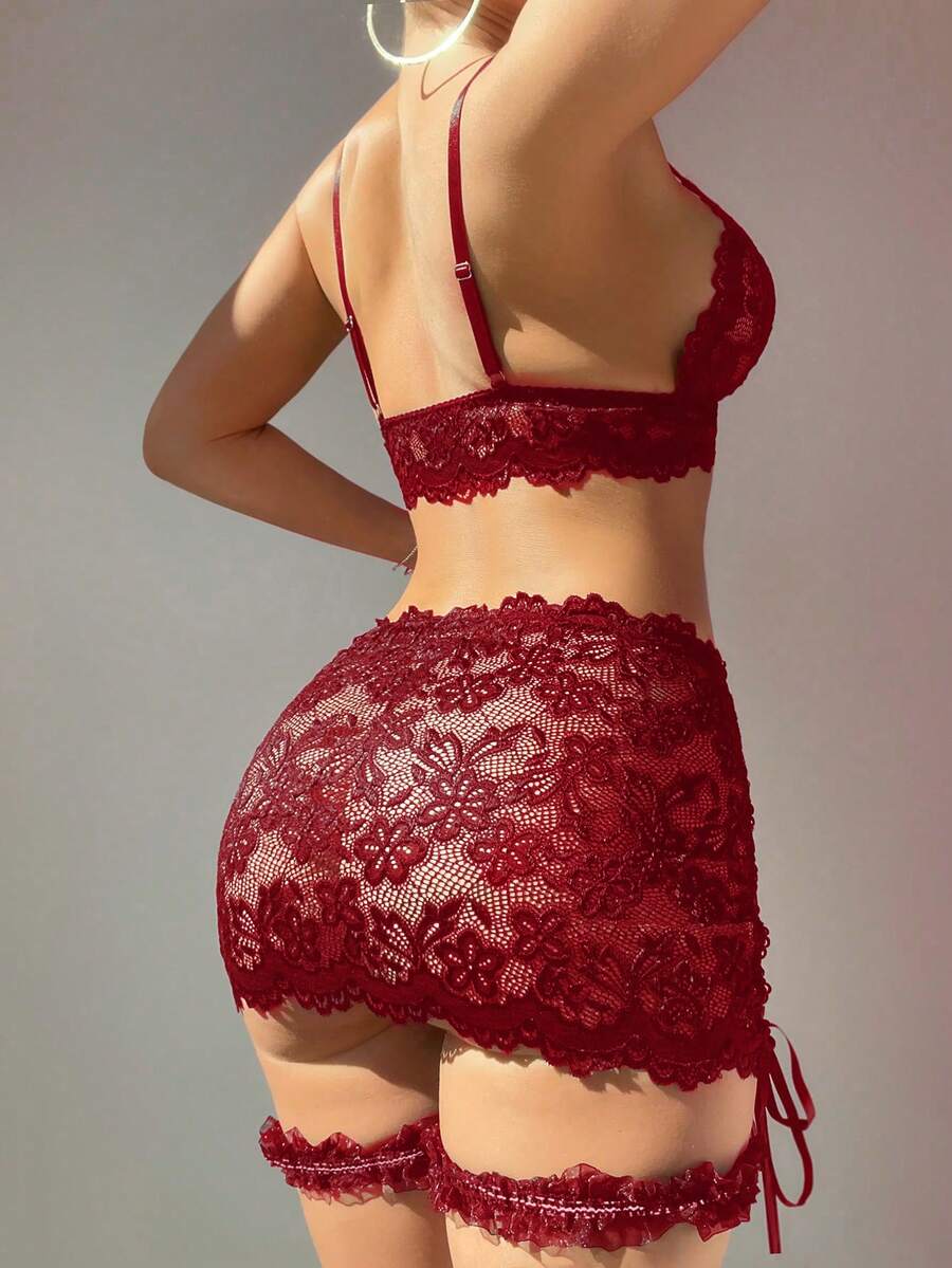 Black 4-piece women's lace bodycon dress lingerie set featuring heart rhinestone spaghetti straps, wireless bralette, thong, and ruffle hem garter.
