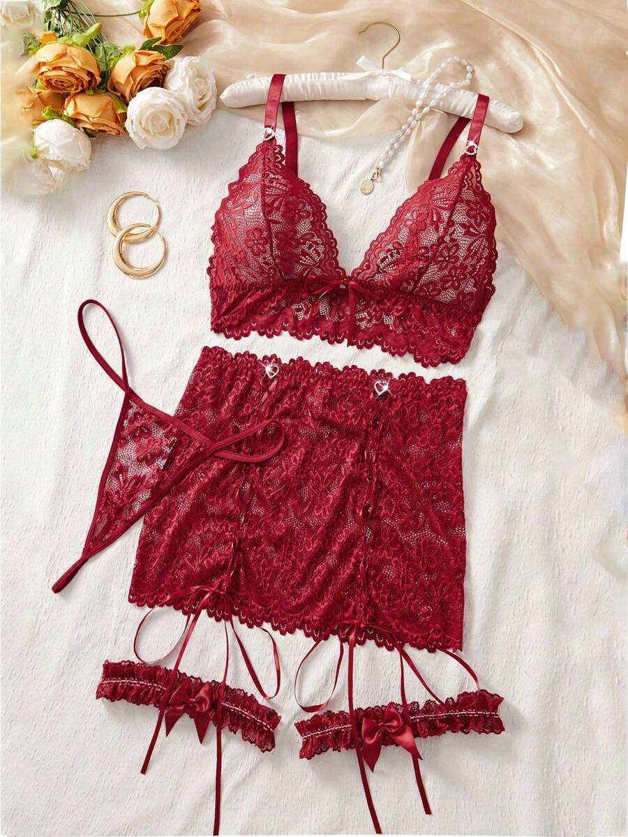 Black 4-piece women's lace bodycon dress lingerie set featuring heart rhinestone spaghetti straps, wireless bralette, thong, and ruffle hem garter.