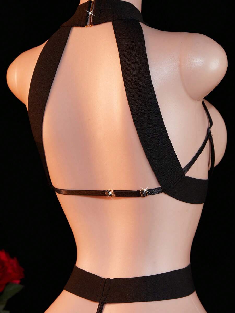 Women's black backless lingerie bodysuit featuring halter neck, cut-out details, underwire bra, and adjustable straps.