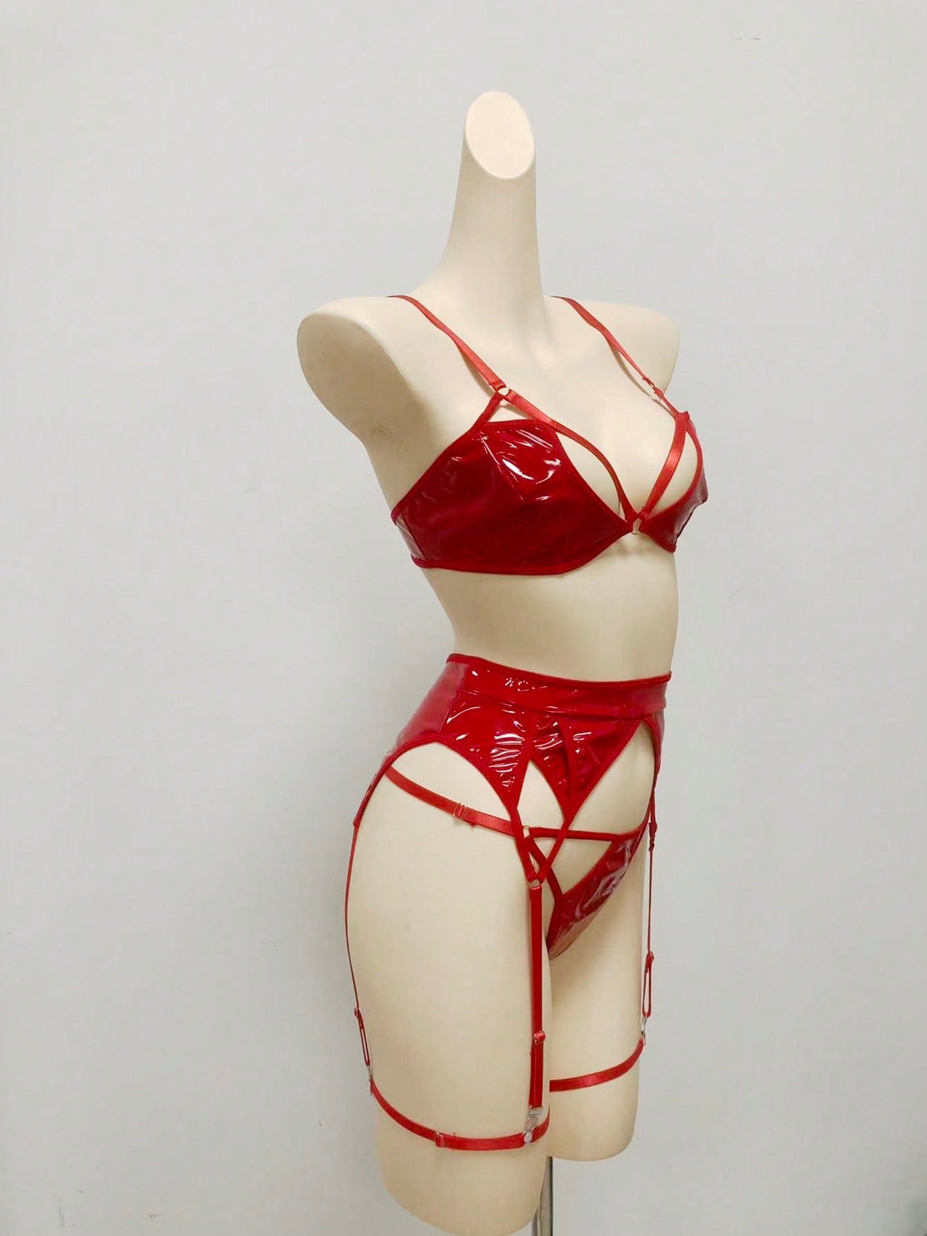 Women's 4-piece wireless lingerie set with cut-out bralette, adjustable spaghetti straps, V-string panty, and matching body accessories in plain style.