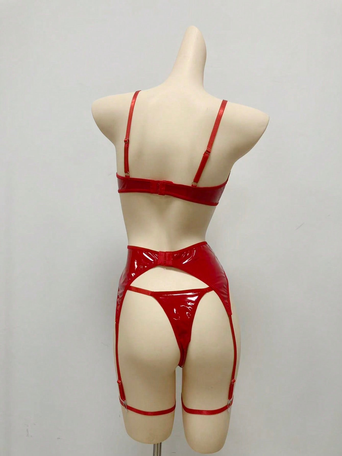 Women's 4-piece wireless lingerie set with cut-out bralette, adjustable spaghetti straps, V-string panty, and matching body accessories in plain style.