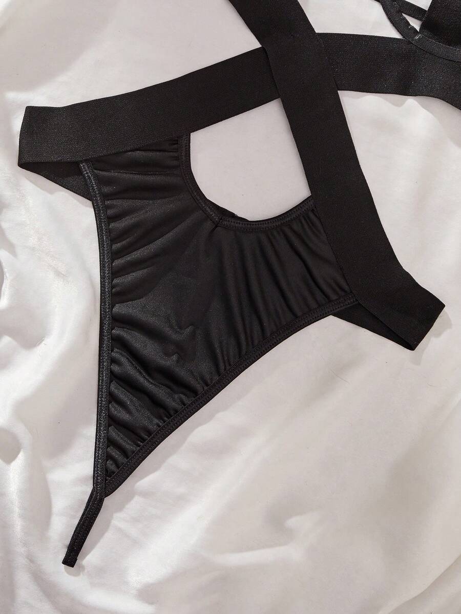 Women's black backless lingerie bodysuit featuring halter neck, cut-out details, underwire bra, and adjustable straps.