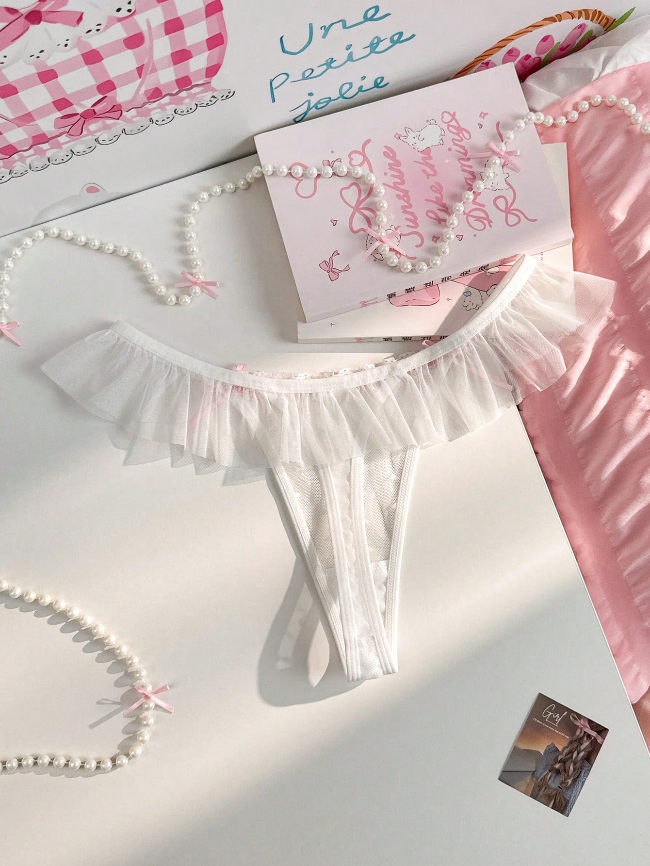Women's ruffled mesh thong panty with bow detail and mid rise fit, plain design, 1-piece style
