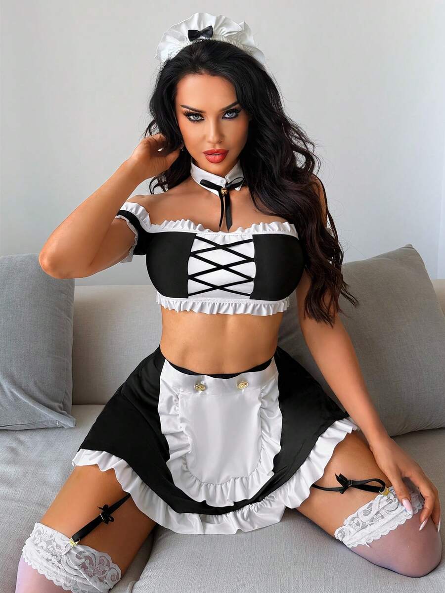 Women's 5-piece black and white cosplay lingerie set including a cold-shoulder top with lace trim, bow-back apron, mini skirt, headband, and bell accessory.