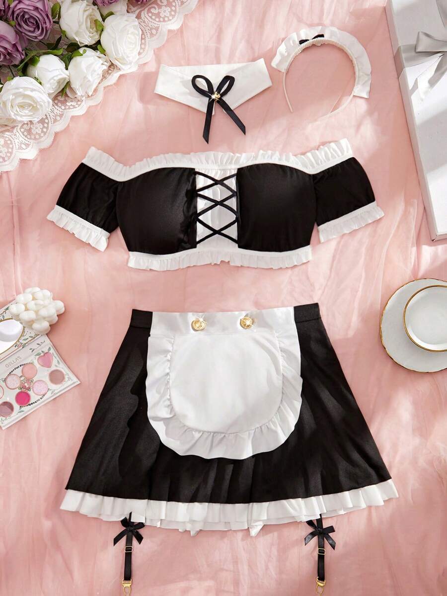 Women's 5-piece black and white cosplay lingerie set including a cold-shoulder top with lace trim, bow-back apron, mini skirt, headband, and bell accessory.