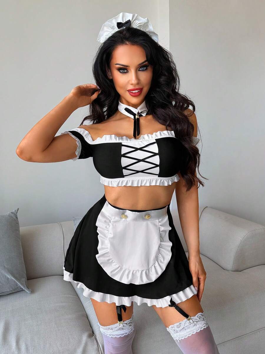 Women's 5-piece black and white cosplay lingerie set including a cold-shoulder top with lace trim, bow-back apron, mini skirt, headband, and bell accessory.