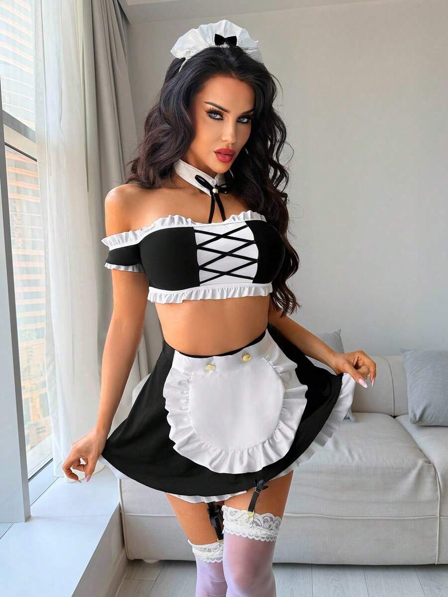 Women's 5-piece black and white cosplay lingerie set including a cold-shoulder top with lace trim, bow-back apron, mini skirt, headband, and bell accessory.