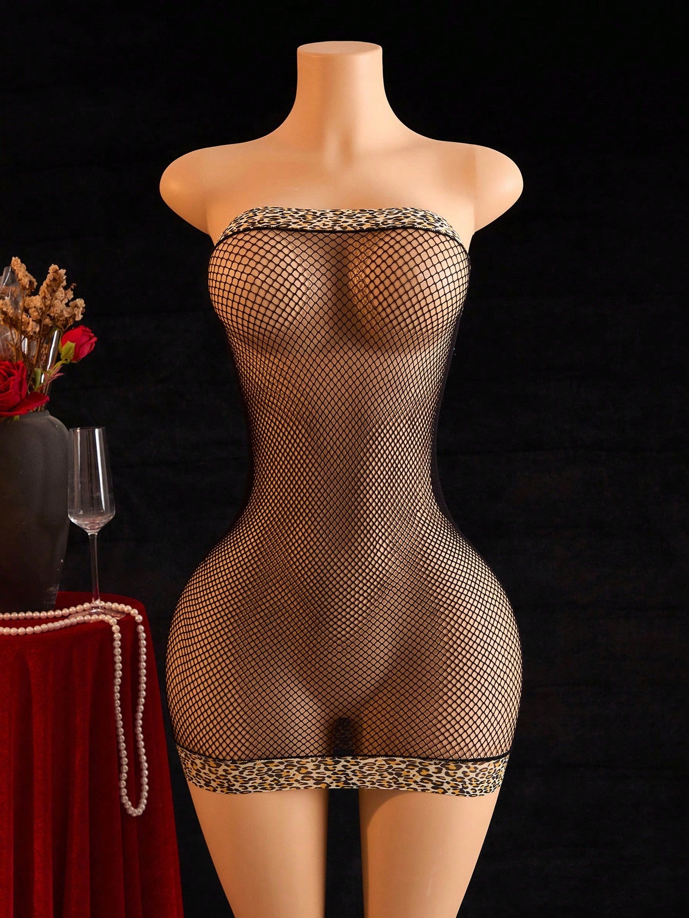 Sheer black fishnet babydoll chemise for women with strapless bandeau neckline, hollow out detail, mini length, and high-stretch wireless design.