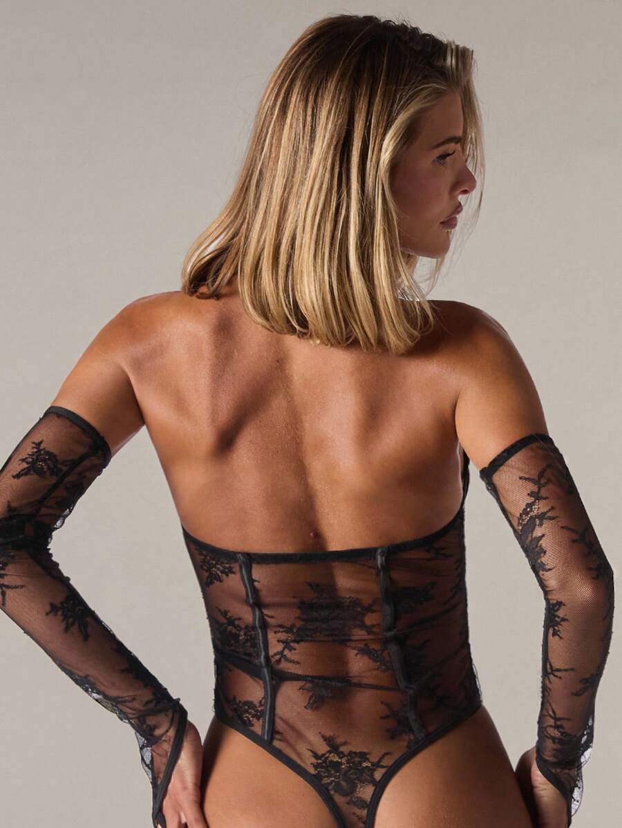 Women's 3-piece black sheer lace lingerie set featuring a bandeau bodysuit, wireless bralette, and V-string panty.