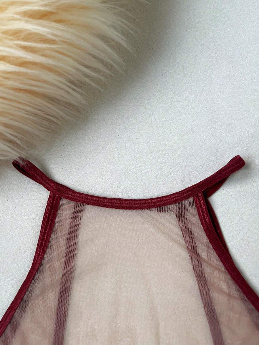 Women's sheer floral mesh teddy camisole featuring cut-out backless design, round neck, adjustable straps, and thong panty in burgundy.