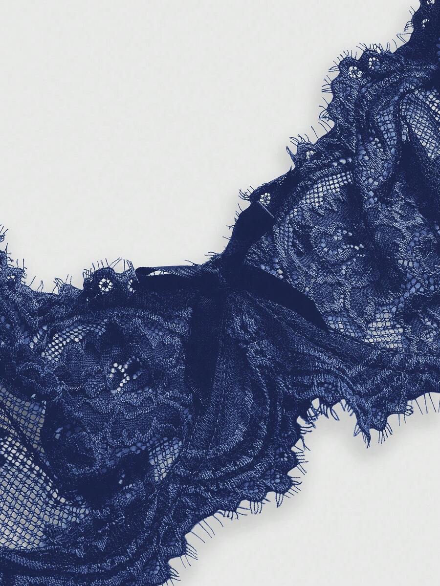 Black sheer floral lace plunge bra featuring underwire support, unlined triangle cups, adjustable straps, and a backless design for women.
