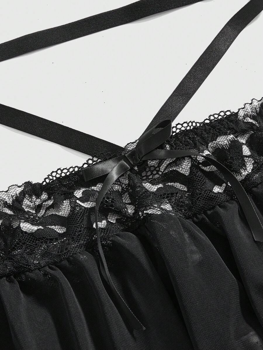 Black plus size gothic lingerie set featuring an off-shoulder bra with metal chain straps, underwire support, low rise thong, and ruffle hem mini skirt.