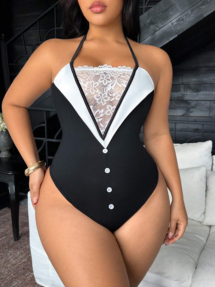 Plus size woman wearing a black and white contrast lace backless halter bodysuit with tie knot neck, pompom back detail, and wireless teddy design.